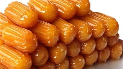 طريقة عمل بلح الشام المقرمش بالنشا.. متعى اسرتك بطعم منتجات الحلوانى 